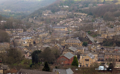 Fototapeta na wymiar panoramic view of the town of hebden bridge showing the main roads, houses and streets with mill chimneys in winter