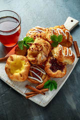 Freshly Baked Traditional pastry Sweet mini Danish Sticky maple pecan, Cinnamon, Apple, Raspberry mix with hot strawberry Tea