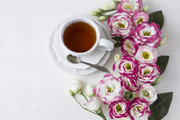 Bouquet of beautiful flowers with cup of tea. Holidays background: March 8, valentine's day, mother's day, wedding, engagement