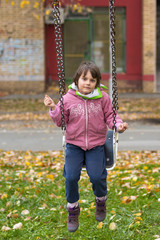 Little girl on swing at playground