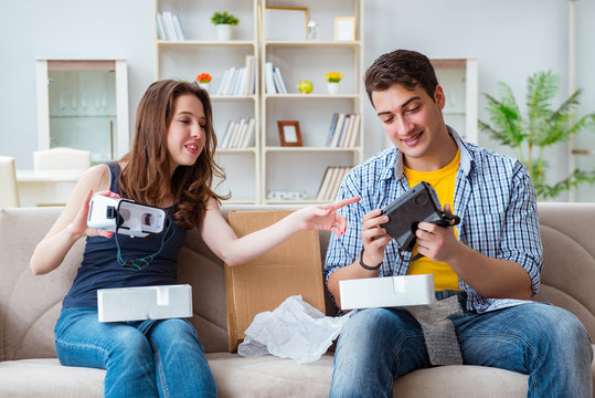 Young family playing games with virtual reality glasses