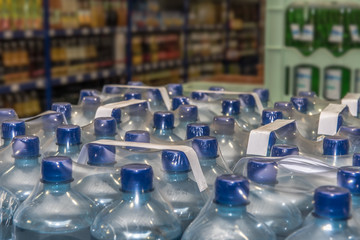 Mineral water in disposable containers are in a beverage market. Water basis of all life. Concept: drinks or health