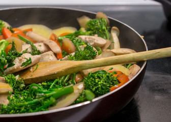 Cooking chicken stir-fry in cast iron skillet