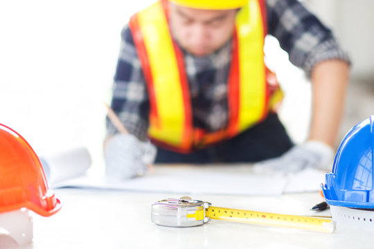 engineer sketh a comstruction plan on drawing paper