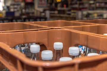 Water drink crates stand in a beverage market. Drinks in reusable containers stand for sustainability. Concept: drinks or environmental protection