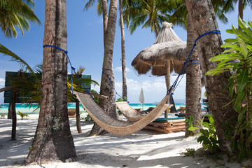Chaise longues and hammock at the beach on the Boracay island, Philippines