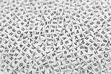  scattered cyrilic letters on white background black and white photo