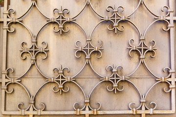 Old Decorative textured metal lattice on a wall