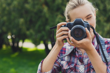 Young woman taking pictures outdoors