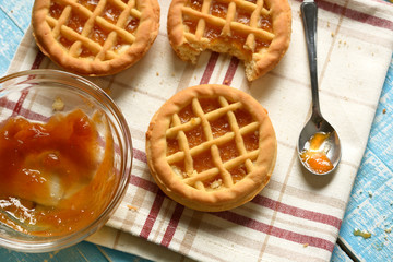small pies with ingredients around on light blue table © ELENA59
