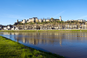 Fototapeta na wymiar Chinon town with its chateau on the hill above in spring afternoon sunshine on the banks of the River Vienne, Indre-et-Loire, France