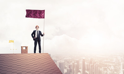 Young businessman with flag presenting concept of leadership. Mi