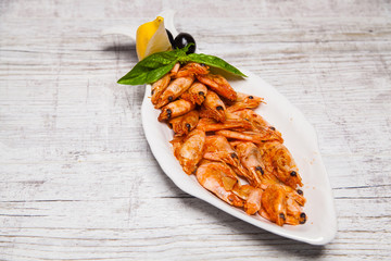 shrimp with lemon on a wooden background