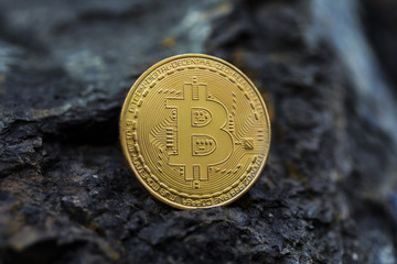  Golden bitcoin as main digital currency worldwide presented on the stone.
