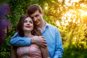 Fototapeta premium Portrait of young love couple in the garden