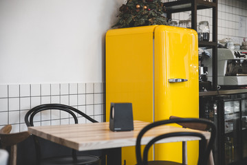 bright retro yellow fridge in coffeehouse