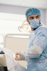 Doctor surgeon during stomatology surgery in dentistry room