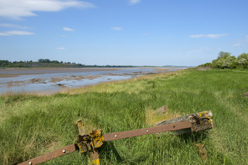Obsolete small boats and barges were stranded on the banks of the tidal River Severn in Gloucestershire, UK to protect the river banks from erosion.