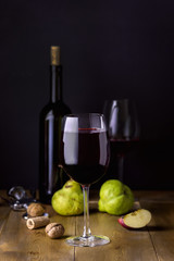 Red Wine Glasses and Bottle on Wooden Black Background Vertical Dark Ripe Fruits Apple Pears Wine Drink