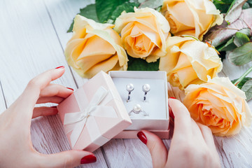 Woman opens a gift box with jewellery