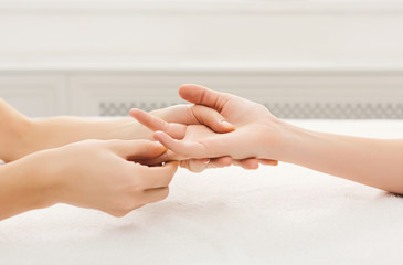 Hand massage at spa salon on white towel