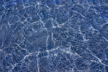 Texture of transparent sea waves in sunlight