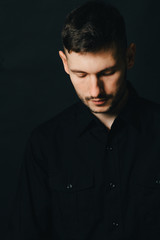 Obraz premium Man in headphones and black shirt on a black background