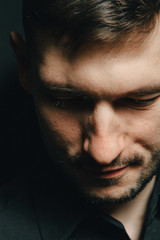 Man in headphones and black shirt on a black background
