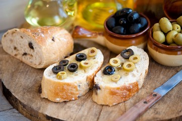 bread with olives and olive oil, olive oil in bottles