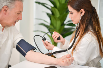 Doctor checking blood pressure