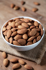 Almond snack fruit in white bowl on wooden