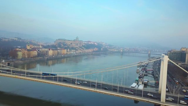 Budapest, Hungary - Aerial footage of drone flying next to Elisabeth Bridge over River Danube with Buda Castle Royal Palace at background