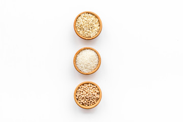 Healthy breakfast. Various cereals in bowls on white background top view copy space