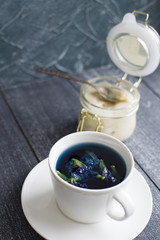 Obraz na płótnie Canvas Vertically background with blue tea and honey