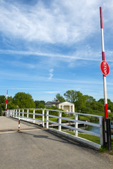 Late spring sunshine on Splatt Bridge and bridge keepers cottage on the Gloucester & Sharpness Canal at Frampton on Severn, Gloucestershire, UK