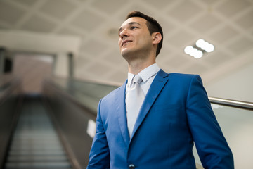 Businessman on Escalator