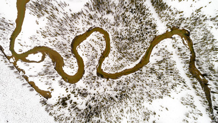 Aerial view of Redfish Creek in winter with snow and trees
