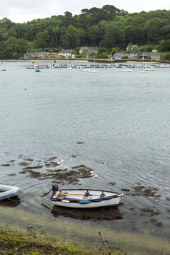 Looking across the Helford Estuary from the village of Helford at the many small boats at moorings around Helford Passage, Cornwall, UK