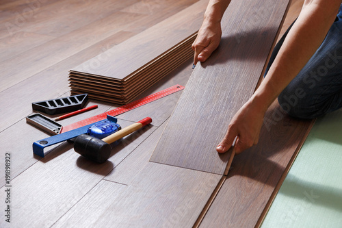 Man Laying Laminate Flooring Closeup On Male Hands Stock Photo Man Laying Laminate Flooring Closeup On Male Hands