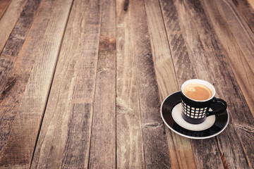 Single small coffee cup on wooden background