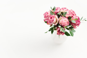 Fototapeta na wymiar Pink rose flowers bouquet on white background. Minimal spring floral concept.