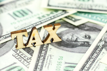 Tax Word On dollar bills background