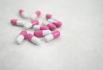 pink white medicine pills on white background