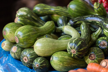 Close up of  green courgettes at a market vegetable stall