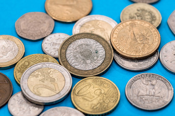 Different Pound coins on a blue background.