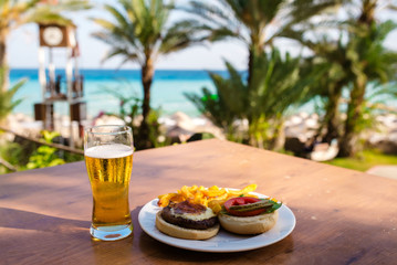 beer and Burger against the sea.
