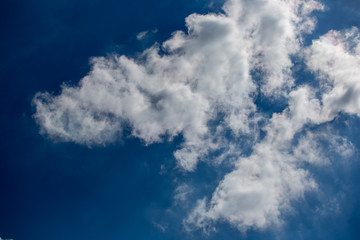 White clouds on dark blue sky