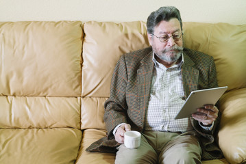 Fototapeta premium Man of 72 years old of age with tablet
