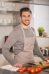 man in home kitchen preparing pasta dish