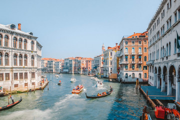 Gondolas and motor boats with tourists traveling the Grand Canal in Venice, Italy